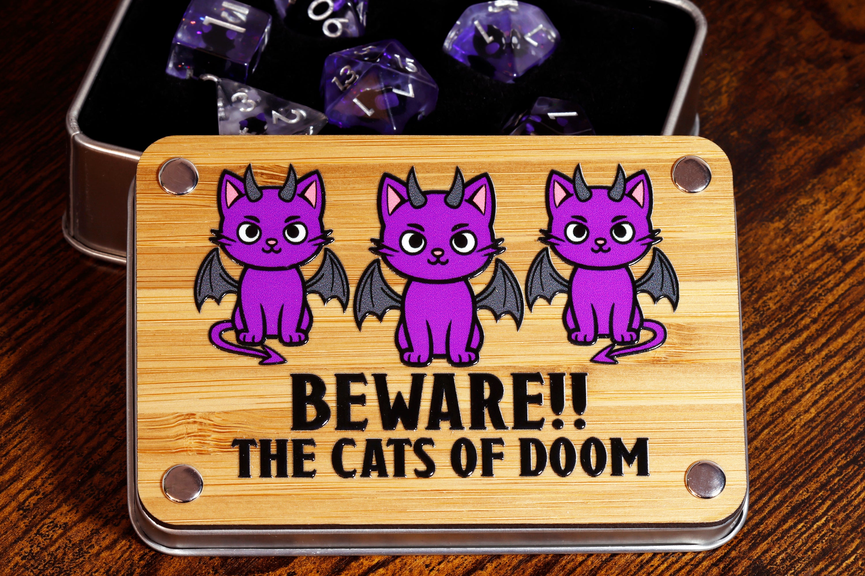 a tin of dices with purple cats on them