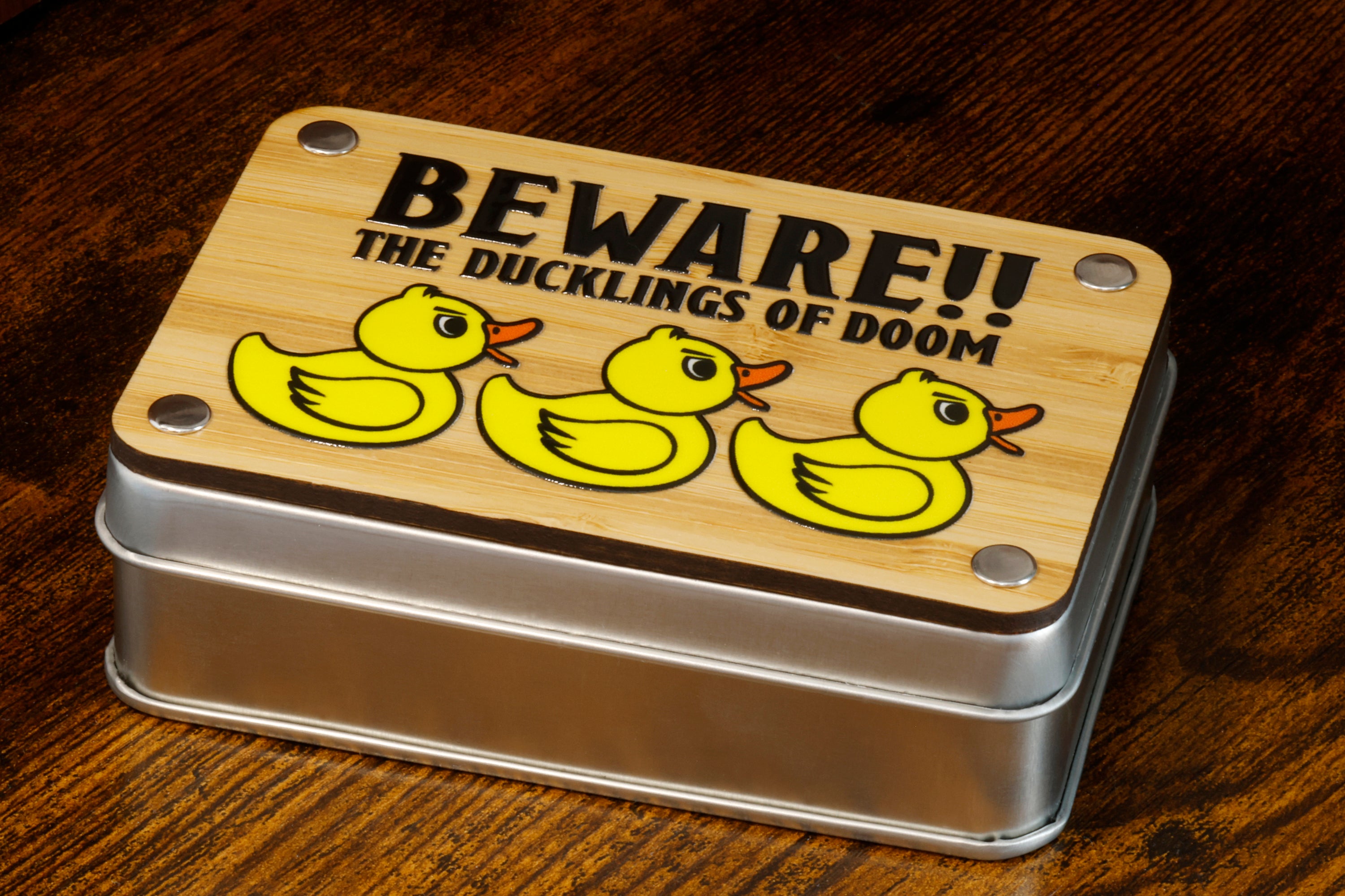 a tin with a picture of three rubber ducks on it