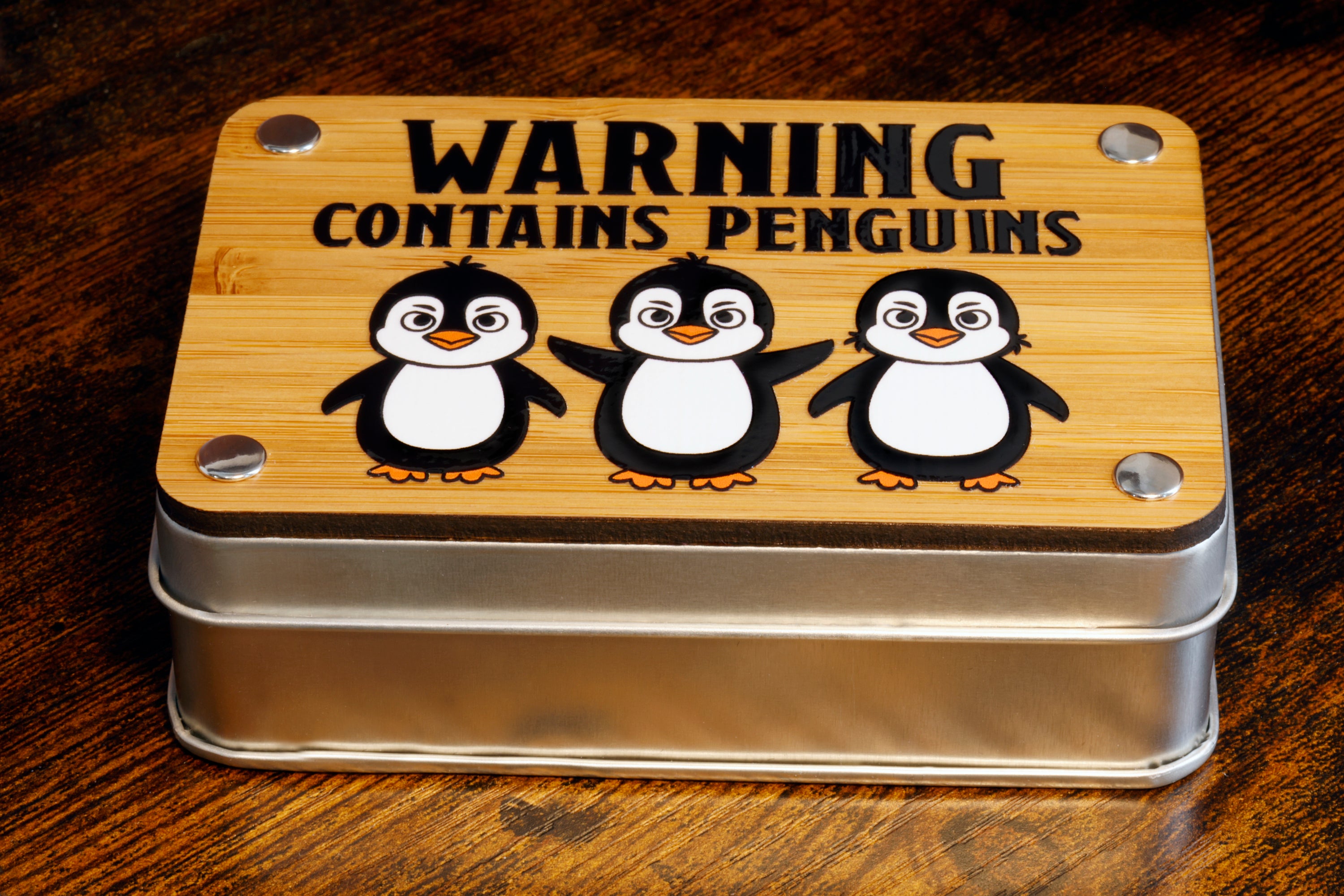 a metal container with a picture of three penguins on it