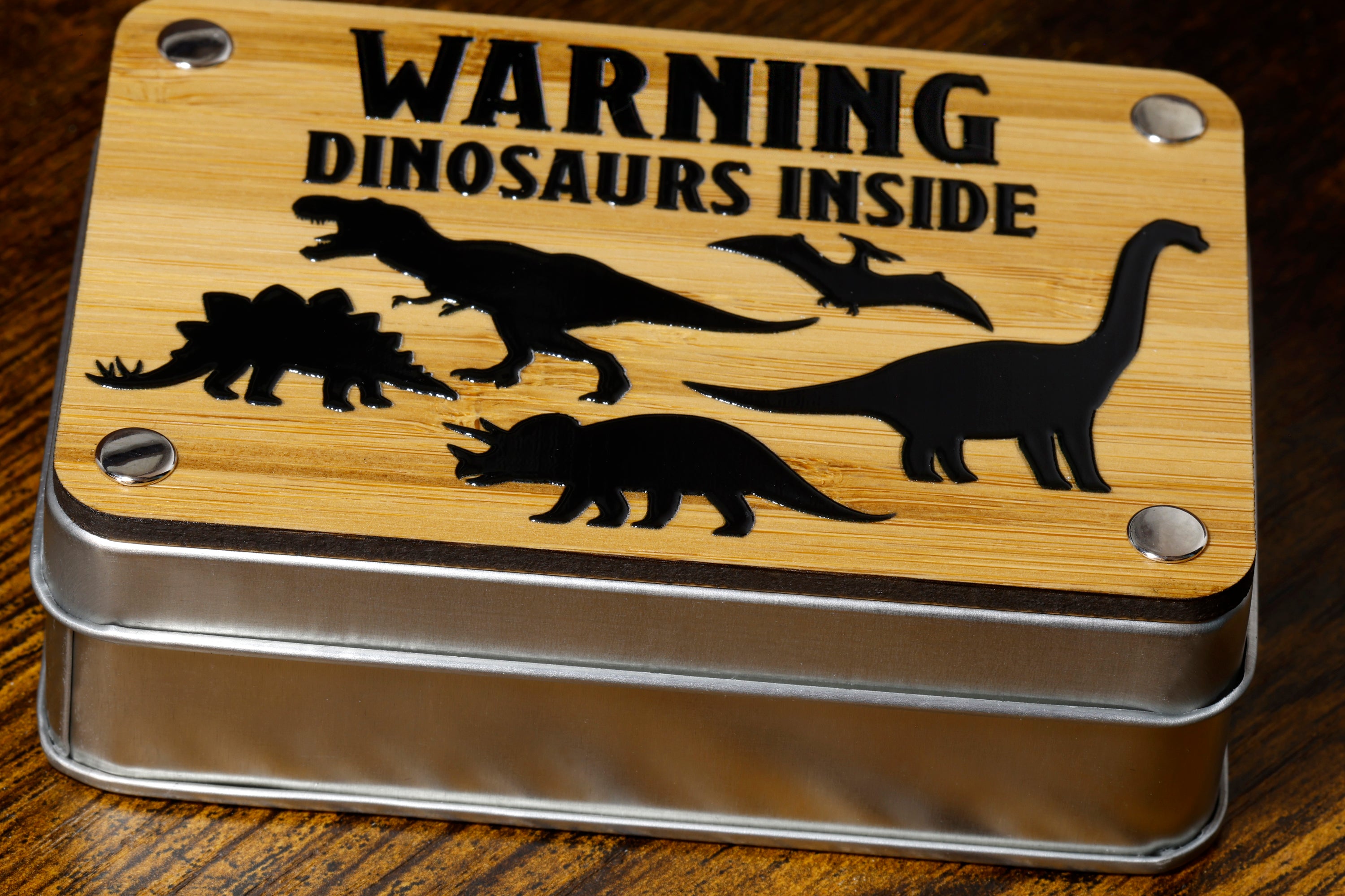 a tin with a picture of dinosaurs inside of it