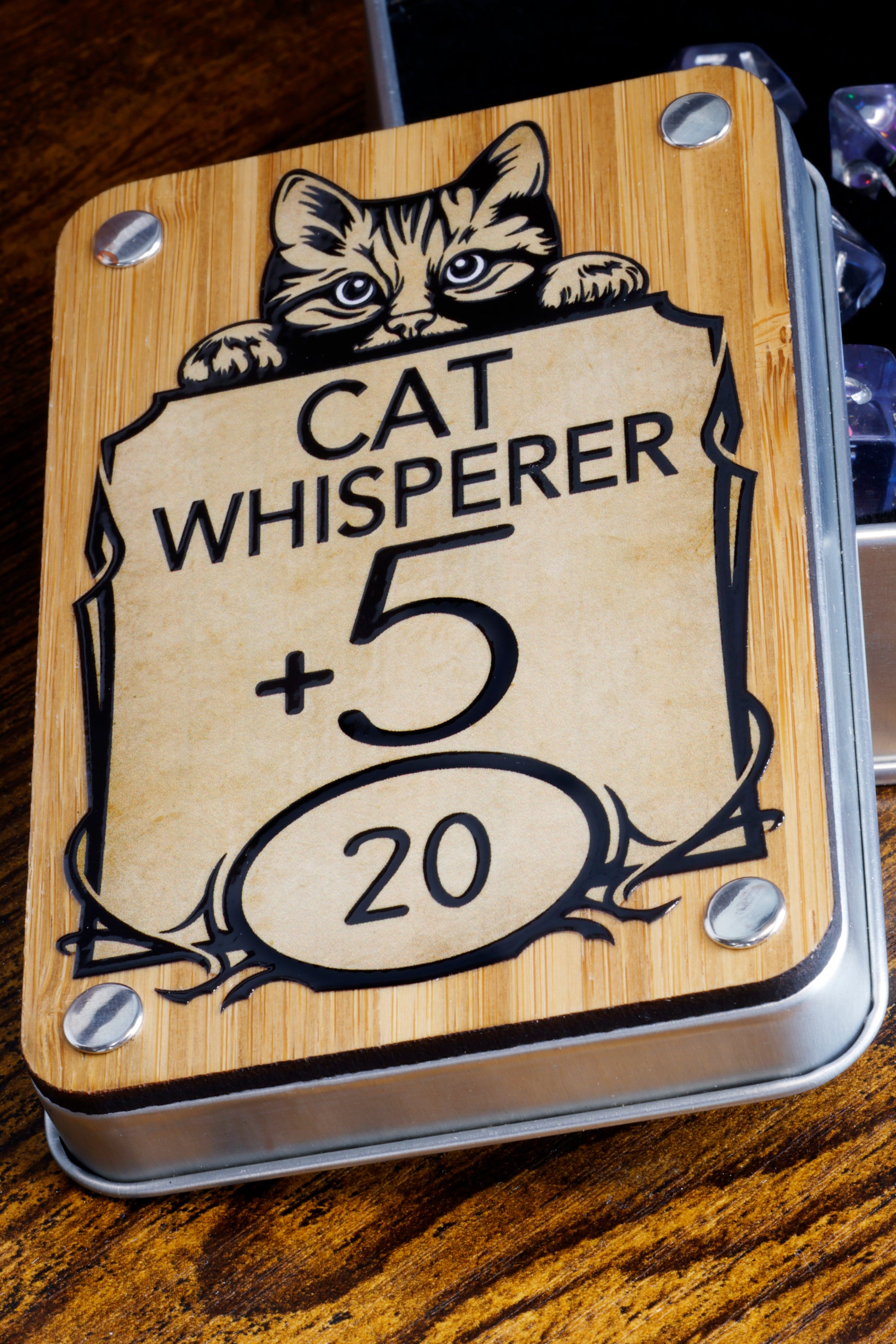 a wooden sign with a cat on it on a table